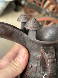 A Chinese archaic bronze wine vessel with taotie design, 'jue 爵', Zhou
