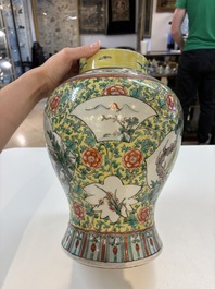 A pair of Chinese famille verte yellow-ground 'Xi Xiang Ji' vases and covers, 19th C.