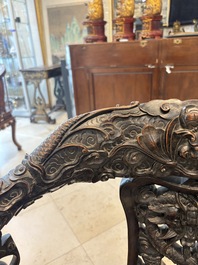A pair of Chinese finely carved hongmu swivel chairs, Canton, 19th C.