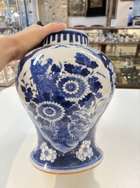 A pair of Chinese blue and white covered vases with floral design, 19th C.