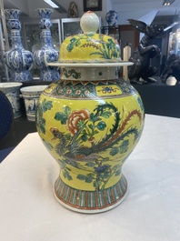 A pair of Chinese famille verte yellow-ground 'pheasants and peonies' vases and covers, 19th C.