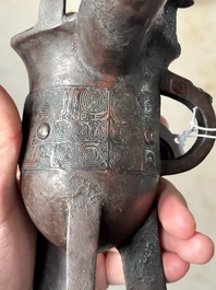 A Chinese archaic bronze wine vessel with taotie design, 'jue 爵', Zhou