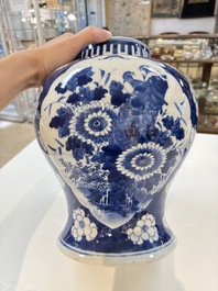 A pair of Chinese blue and white covered vases with floral design, 19th C.