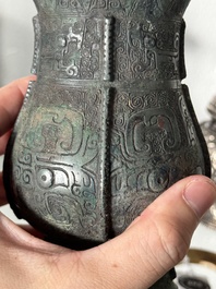A Chinese archaic bronze food vessel and cover with taotie design, 'zhi 觶', Shang