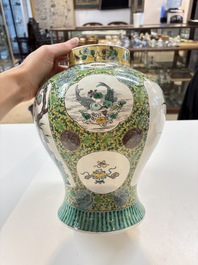 A pair of Chinese verte-biscuit 'cranes and flowers' vases and covers, 19th C.