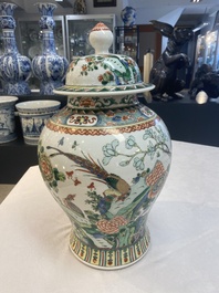 Two Chinese famille verte 'birds and flowers' vases and covers, 19th C.