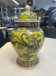 A pair of Chinese famille verte yellow-ground 'pheasants and peonies' vases and covers, 19th C.