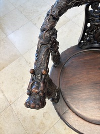 A pair of Chinese finely carved hongmu swivel chairs, Canton, 19th C.