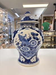 A pair of Chinese blue and white covered vases with floral design, 19th C.