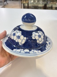 A pair of Chinese blue and white covered vases with floral design, 19th C.