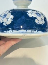 A pair of Chinese blue and white covered vases with floral design, 19th C.