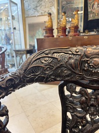 A pair of Chinese finely carved hongmu swivel chairs, Canton, 19th C.