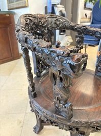 A pair of Chinese finely carved hongmu swivel chairs, Canton, 19th C.