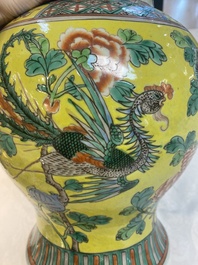 A pair of Chinese famille verte yellow-ground 'pheasants and peonies' vases and covers, 19th C.