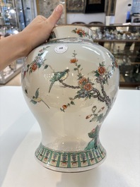 A Chinese famille verte 'phoenixes' vase and cover, 19th C.