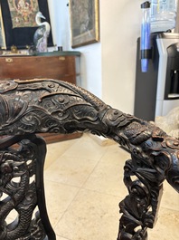A pair of Chinese finely carved hongmu swivel chairs, Canton, 19th C.