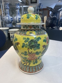 A pair of Chinese famille verte yellow-ground 'pheasants and peonies' vases and covers, 19th C.