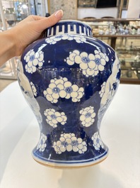 A pair of Chinese blue and white covered vases with floral design, 19th C.