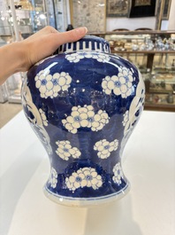A pair of Chinese blue and white covered vases with floral design, 19th C.