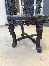 A pair of Chinese finely carved hongmu swivel chairs, Canton, 19th C.