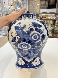 A pair of Chinese blue and white covered vases with floral design, 19th C.