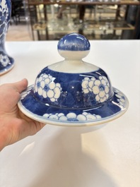 A pair of Chinese blue and white covered vases with floral design, 19th C.