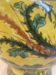 A pair of Chinese famille verte yellow-ground 'pheasants and peonies' vases and covers, 19th C.