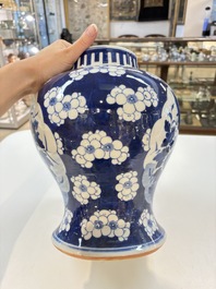 A pair of Chinese blue and white covered vases with floral design, 19th C.
