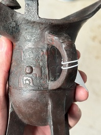 A Chinese archaic bronze wine vessel with taotie design, 'jue 爵', Zhou