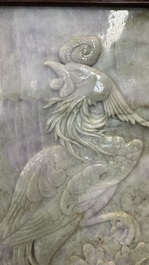 A Chinese lavender and green jadeite 'phoenix' plaque in a hongmu frame, early 20th C.