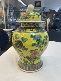 A pair of Chinese famille verte yellow-ground 'pheasants and peonies' vases and covers, 19th C.