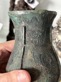 A Chinese archaic bronze food vessel and cover with taotie design, 'zhi 觶', Shang