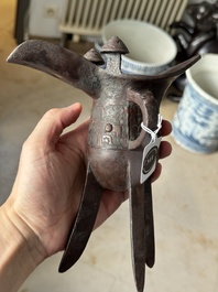 A Chinese archaic bronze wine vessel with taotie design, 'jue 爵', Zhou