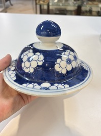 A pair of Chinese blue and white covered vases with floral design, 19th C.