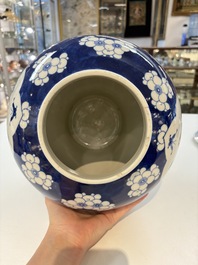 A pair of Chinese blue and white covered vases with floral design, 19th C.