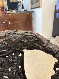 A pair of Chinese finely carved hongmu swivel chairs, Canton, 19th C.