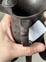 A Chinese archaic bronze wine vessel with taotie design, 'jue 爵', Zhou