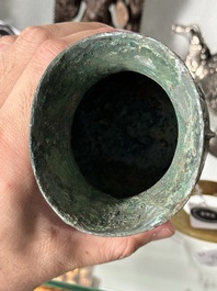 A Chinese archaic bronze food vessel and cover with taotie design, 'zhi 觶', Shang