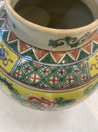 A pair of Chinese famille verte yellow-ground 'pheasants and peonies' vases and covers, 19th C.