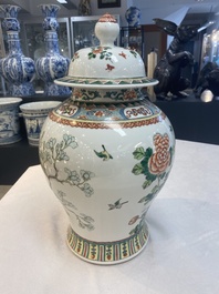 Two Chinese famille verte 'birds and flowers' vases and covers, 19th C.