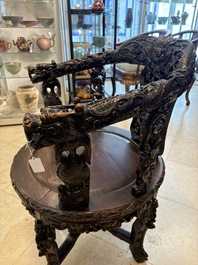 A pair of Chinese finely carved hongmu swivel chairs, Canton, 19th C.