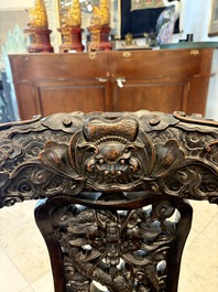 A pair of Chinese finely carved hongmu swivel chairs, Canton, 19th C.