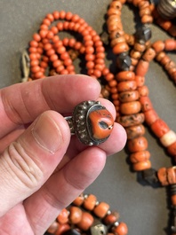 A varied group of five Tibetan necklaces, three rings and four earbobs with red coral, 19/20th C.