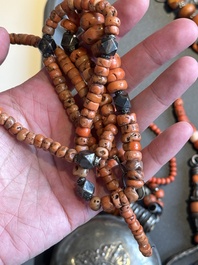 A varied group of five Tibetan necklaces, three rings and four earbobs with red coral, 19/20th C.
