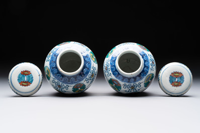 A pair of Chinese doucai 'chrysanthemum' jars and covers, Daoguang mark and of the period