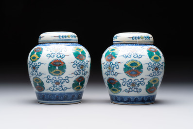 A pair of Chinese doucai 'chrysanthemum' jars and covers, Daoguang mark and of the period