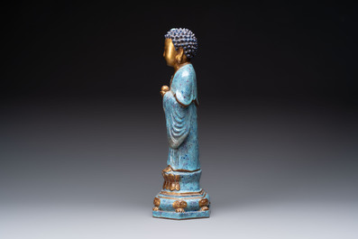 A Chinese robin's egg-glazed gilt-decorated standing Buddha, 18th C.