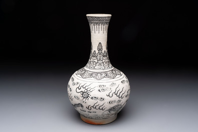 A Chinese black-enamelled biscuit 'dragon' vase, Kangxi mark, 19th C.