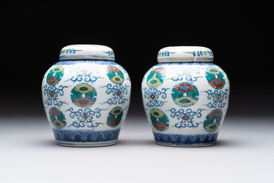 A pair of Chinese doucai 'chrysanthemum' jars and covers, Daoguang mark and of the period