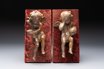 A pair of Flemish allegorical carved wood cherubs, 17th C.